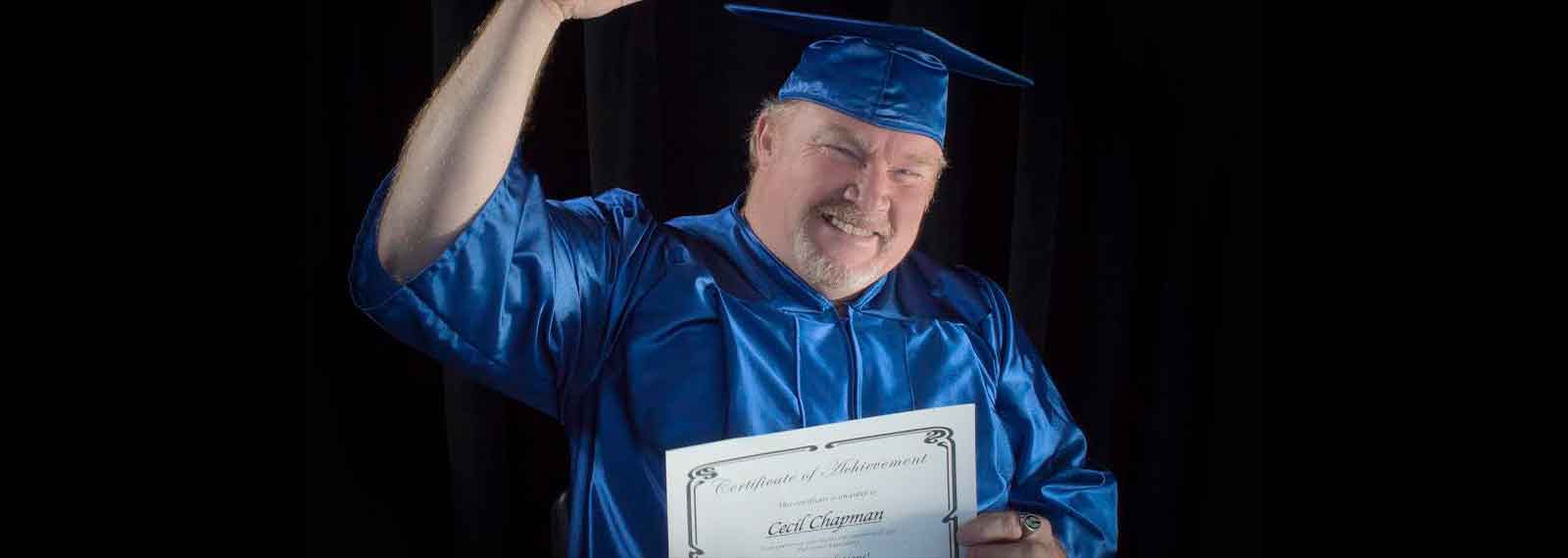 Photo of Cecil Chapman graduating with a diploma.